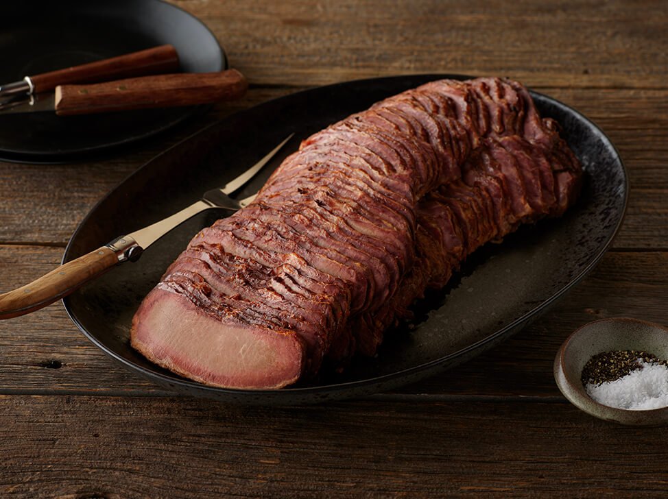 SADLER'S SMOKEHOUSE® TenderSplit beef brisket on a black serving platter.