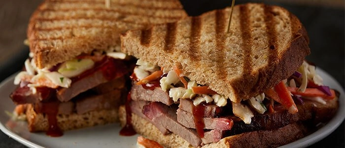 SADLER'S SMOKEHOUSE® brisket in a panini with bbq sauce and slaw.