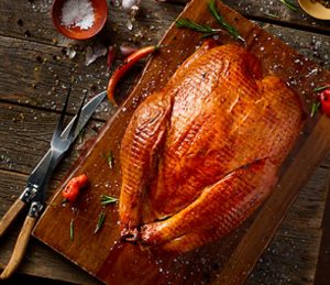 Whole turkey on cutting board.