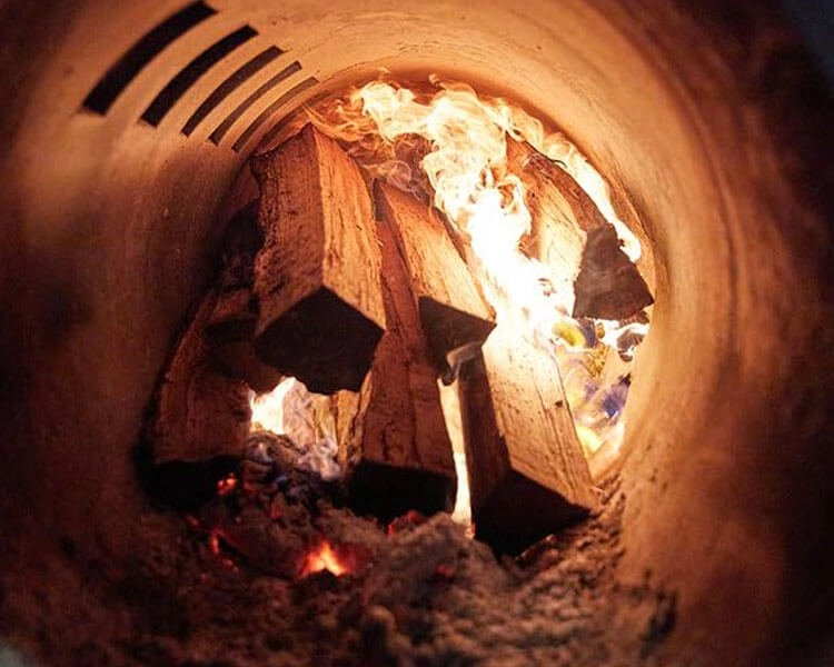 Image of wood burning in a smoker.